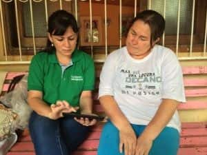 A Fundación Paraguaya field officer conducts a client survey utilizing their tablet-based "semaforo" software.