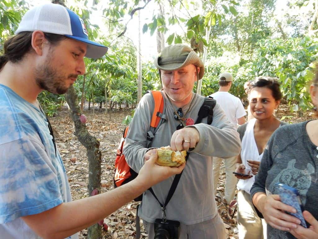 Lee from Madécasse checking out raw cocoa beans with TM Volunteers Sam and Kavita