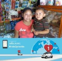 Yajaris, a microcredit client of Pro Mujer, stands in her business with her child