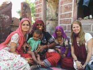 Nioma Sadler (Traditional Medicinals) and Joy Stoddard (Whole Planet Foundation) with a family who’s benefited from the Revive! taanka building program.