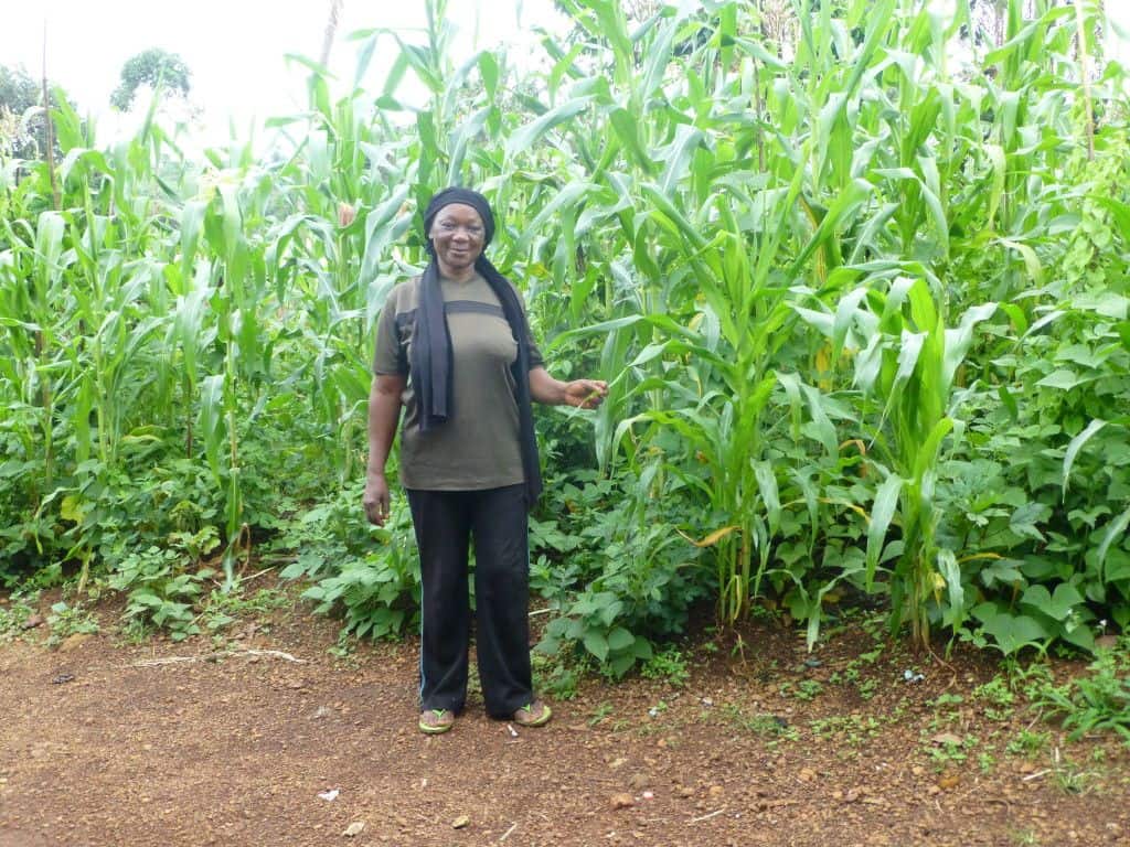 Regina in front of her maize field. Photo: Brian Doe