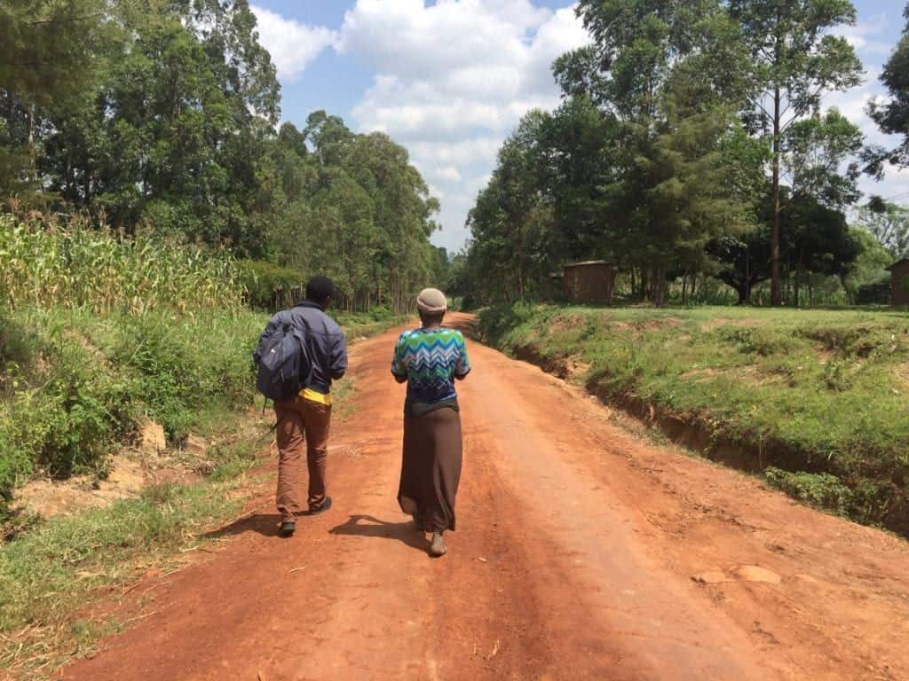 walking down a dirt road in kenya