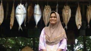 a woman in front of her fish microcredit business in indonesia