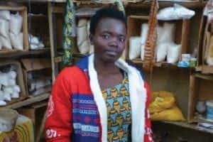 solange is a microcredit client from rwanda standing in her store