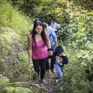 Allegro coffee farmer walking with her son in peru