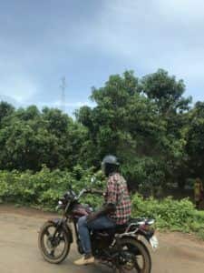 traveling by motorbike microfinance staff