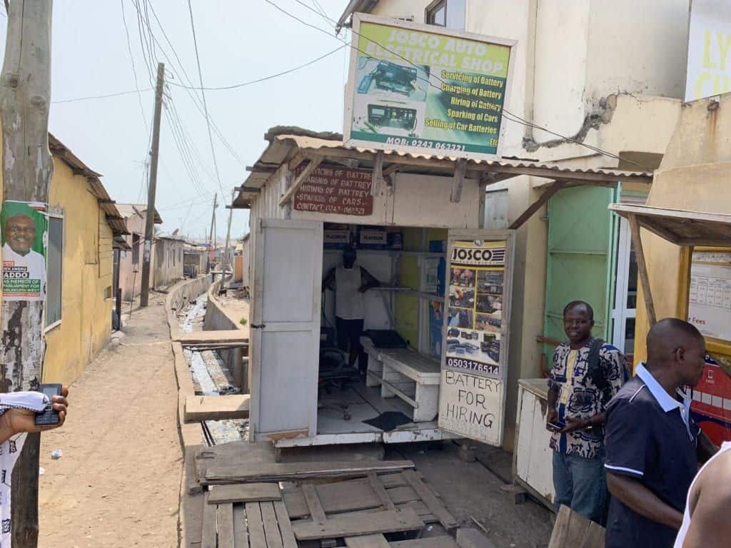 a man standing in front of his shop