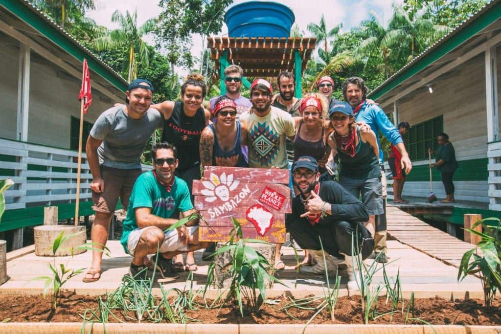 a group of people standing in front of a project in Brazil