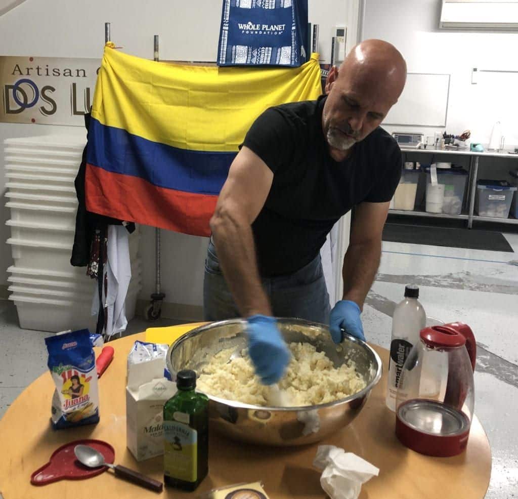 Man stirring arepa dough