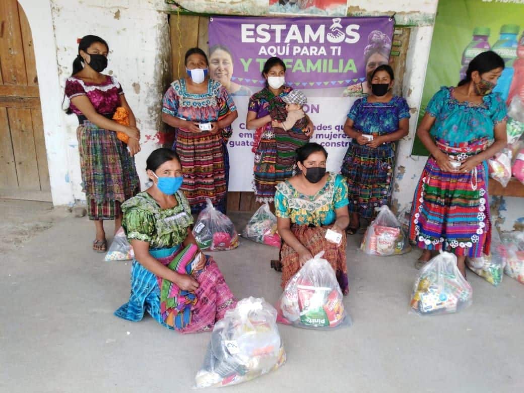 women in guatemala standing with bags of food
