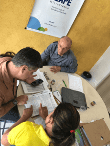 people sitting around a table in a microfinance institution