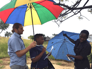 three people with umbrellas