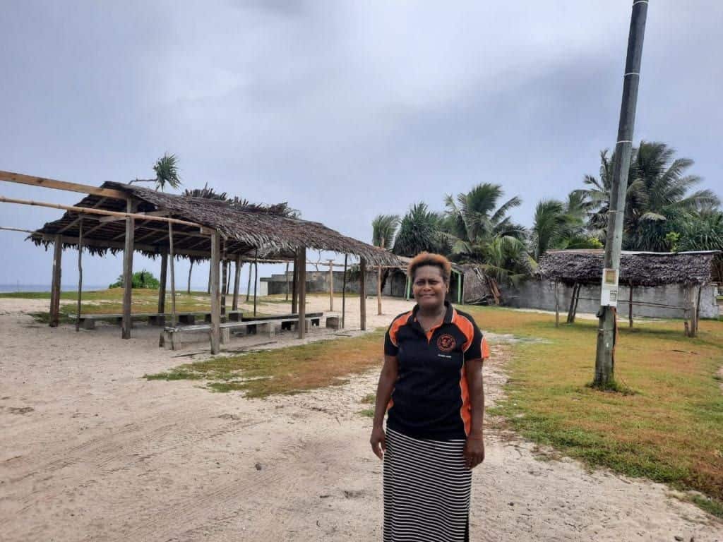 woman standing in front of an empty kiosk