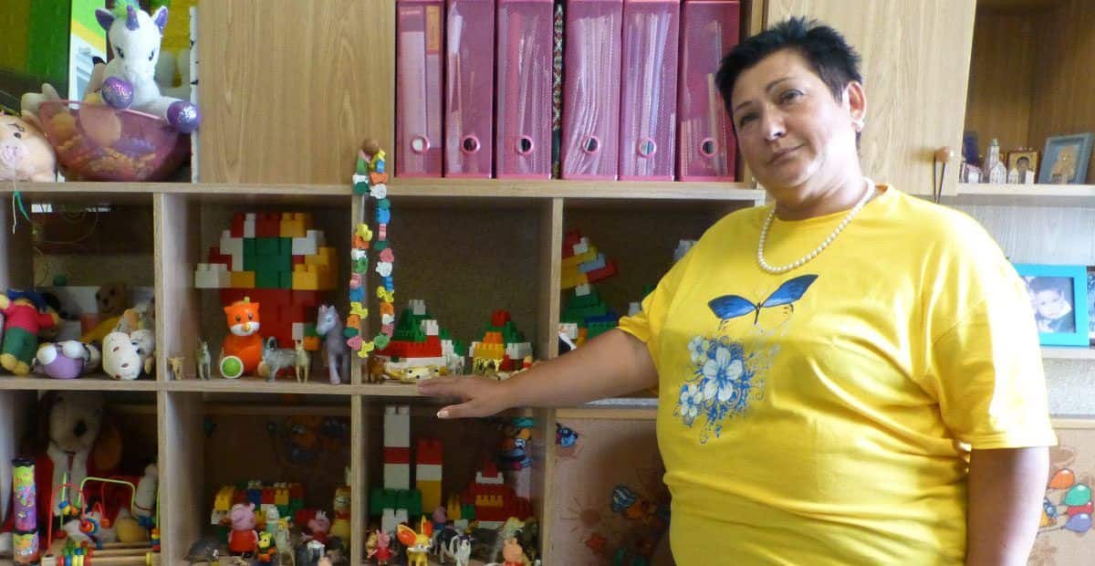 woman standing in front of toys and books