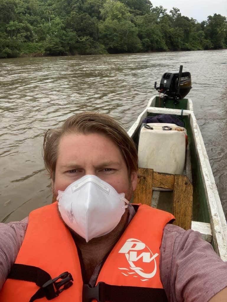 A man wearing a mask in a boat